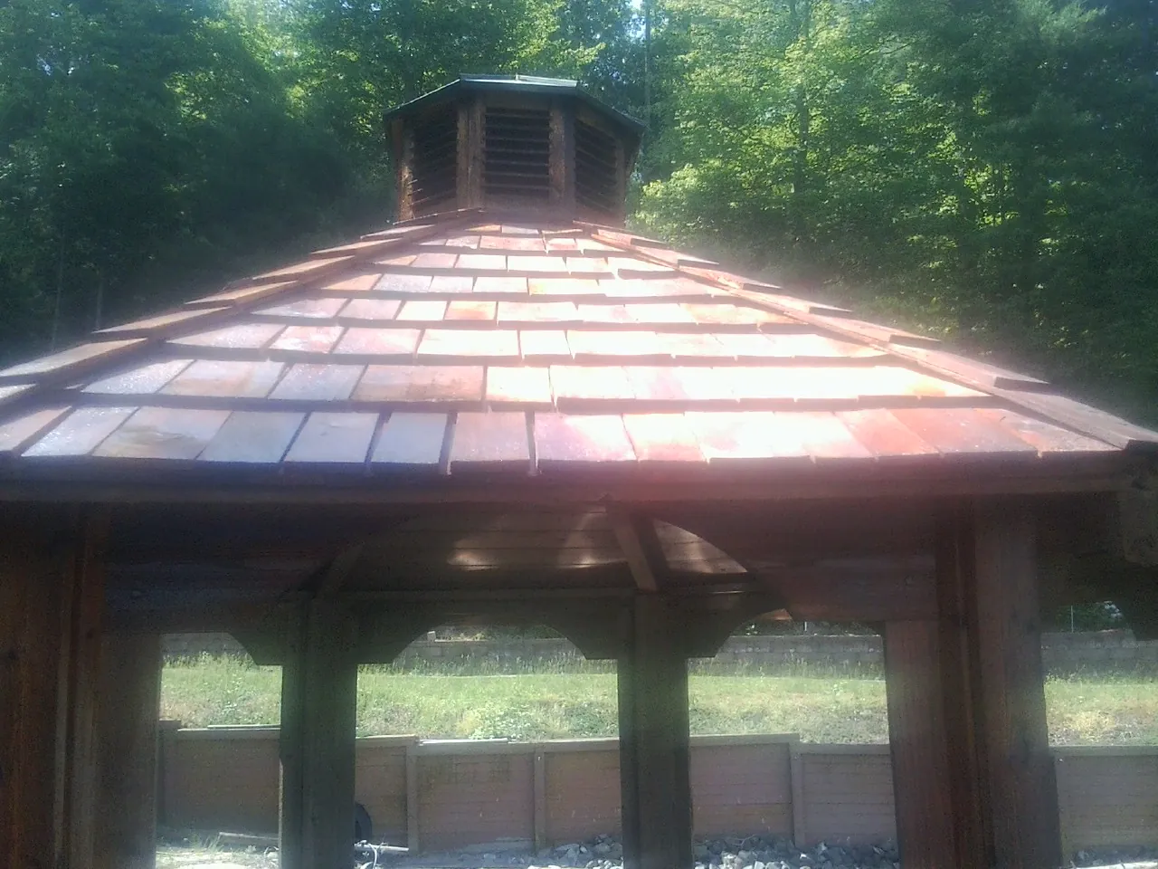 New cedar shake roof and cupola on a lakeside gazebo in Helena